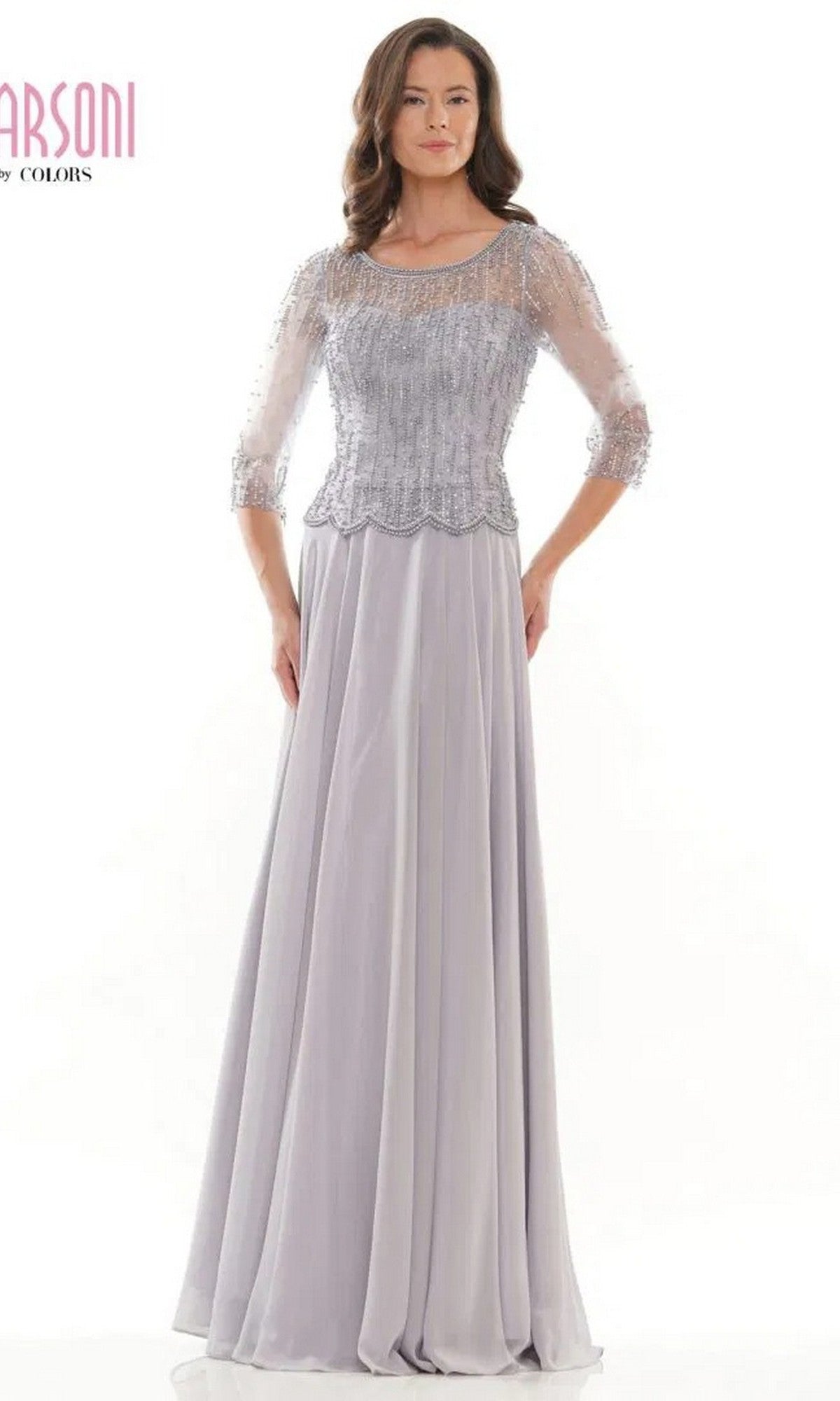 A woman is shown wearing the Marsoni M312 long formal dress in grey, with a sheer beaded bodice, three-quarter sleeves, and an elegant A-line skirt, set against a plain white background.